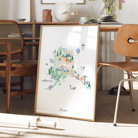 a framed illustration of Alaska, with various landmarks and natural elements depicted in a colorful and artistic style.