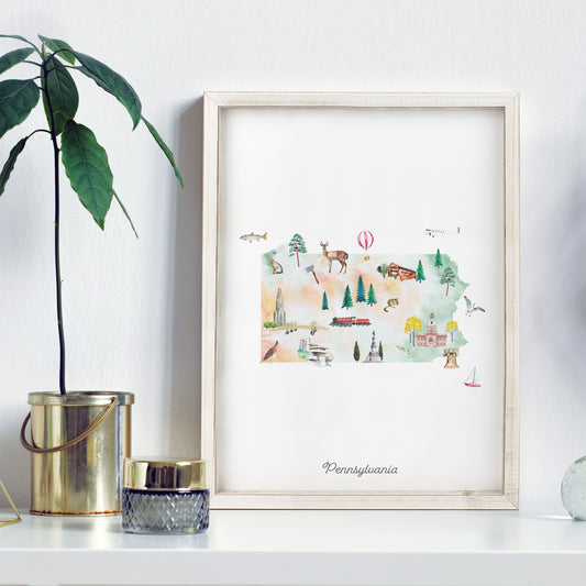 a framed watercolor illustration of Pennsylvania, with various landmarks and scenes depicted, such as a hot air balloon, a train, and a deer.
