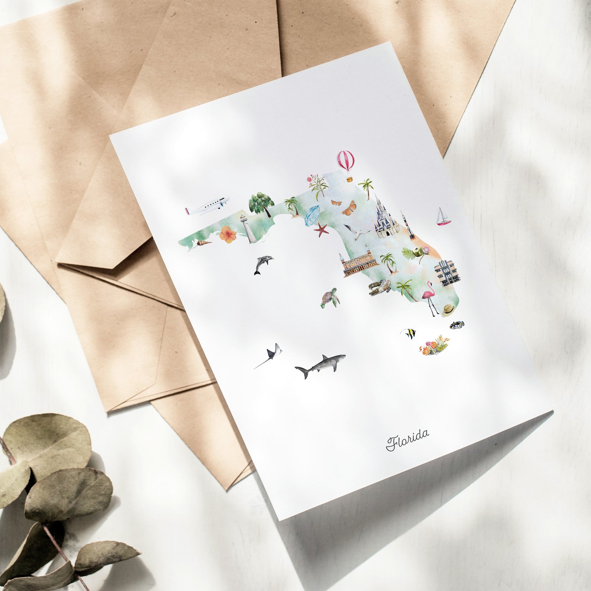 A greeting card featuring a colorful illustration of Florida, with various landmarks and symbols such as a hot air balloon, palm trees, and a shark.