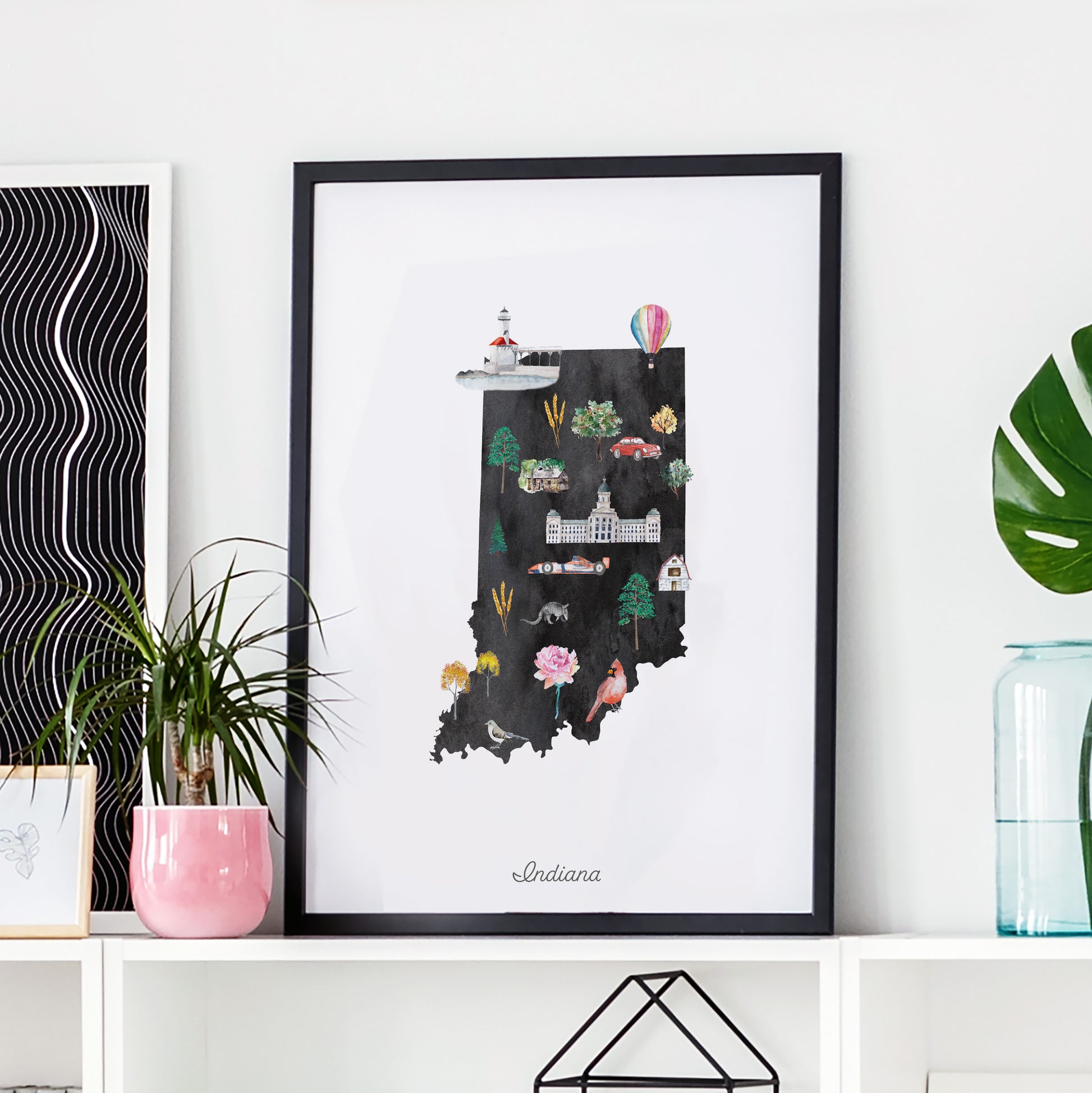 a framed illustration of the state of Indiana, with various landmarks and symbols representing the state.