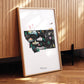 A framed illustration of Montana, featuring various landmarks and natural scenery, is displayed on a wooden surface.