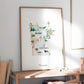 a framed watercolor illustration of Minnesota, depicting various landmarks and scenes from the state.