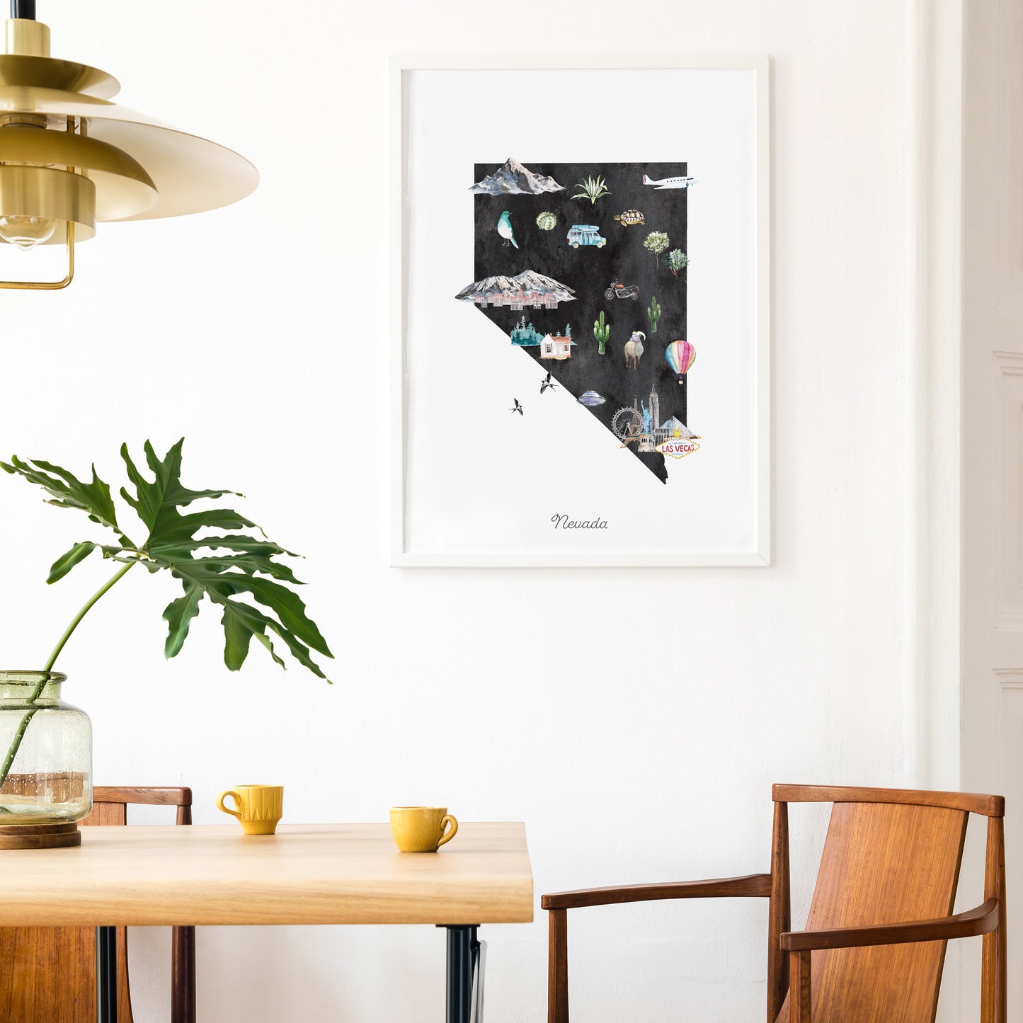 a dining area with a wooden table, two yellow mugs, and a framed poster of the state of Nevada hanging on the wall.