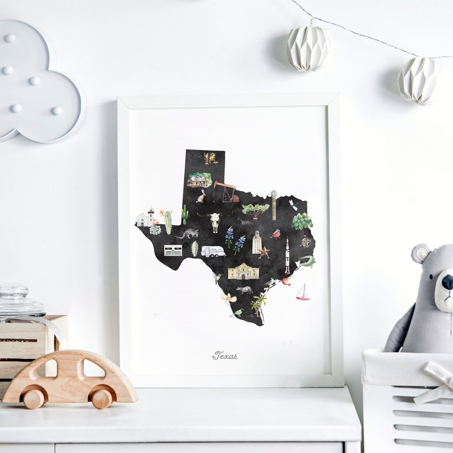a framed illustration of the state of Texas, with various landmarks and symbols representing different aspects of the state.