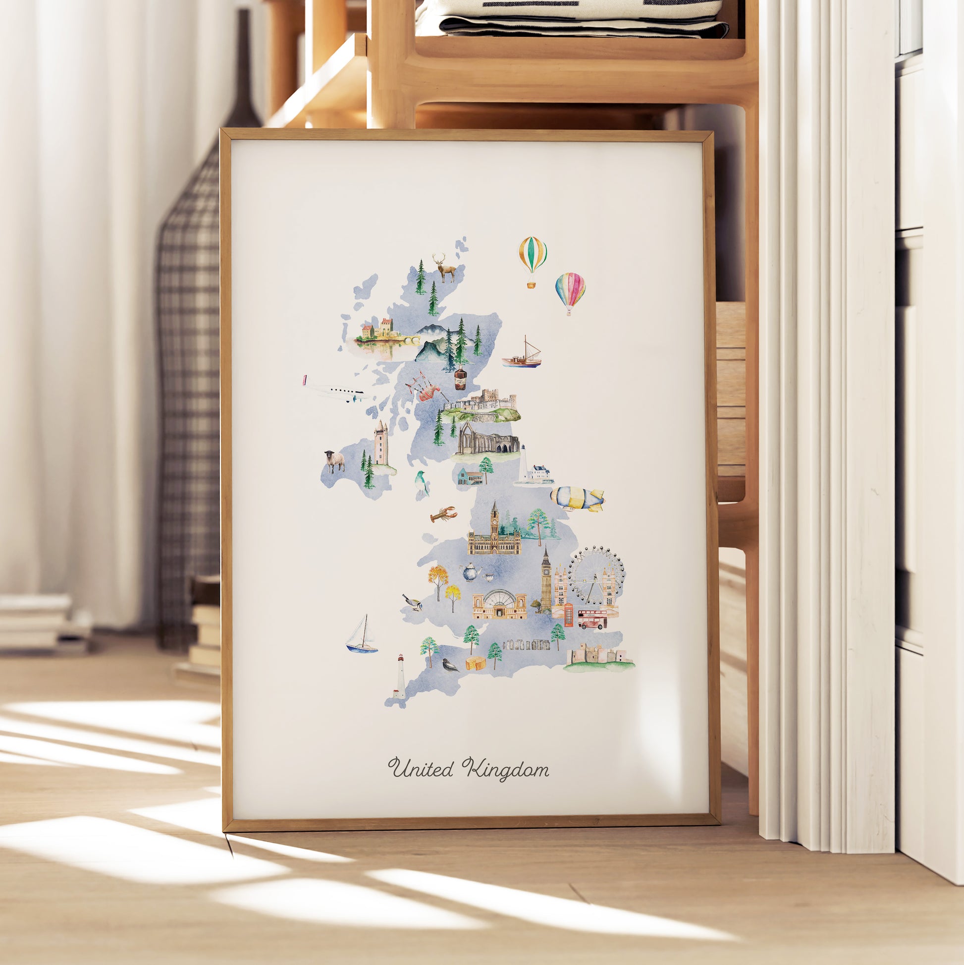 A framed illustration of the United Kingdom, depicting various landmarks and scenes, is displayed on a wooden shelf.