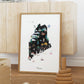 A framed illustration of the state of Maine, featuring various landmarks and scenes typical of the region.