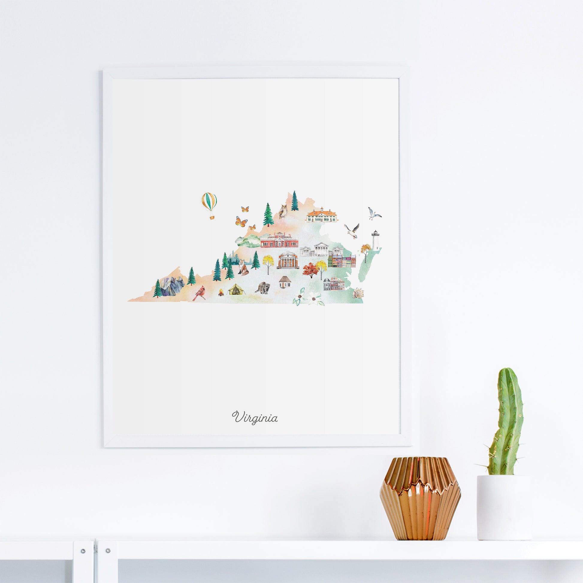 a framed watercolor illustration of Virginia, depicting a scenic landscape with various elements such as buildings, trees, and a hot air balloon.