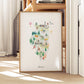 A framed watercolor illustration depicting various landmarks and scenes from Illinois, including a hot air balloon, a church, and a forest.